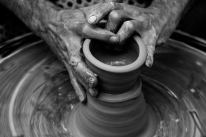 Hands using pottery wheel